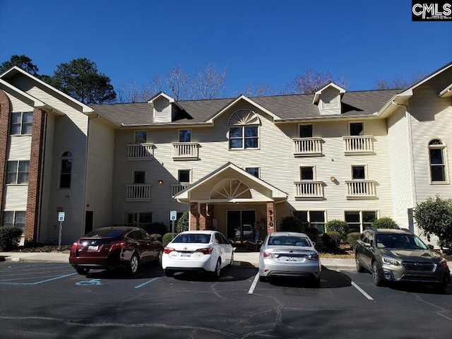 view of building exterior with uncovered parking