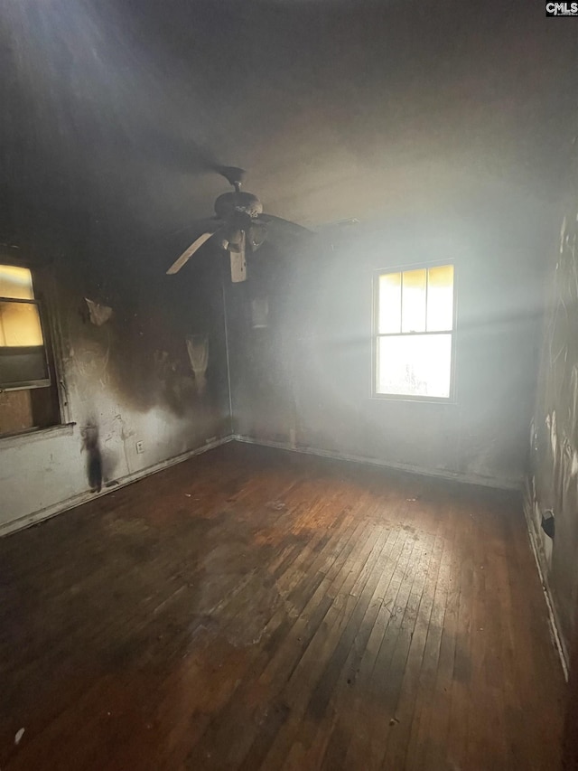 unfurnished room with hardwood / wood-style floors and a ceiling fan