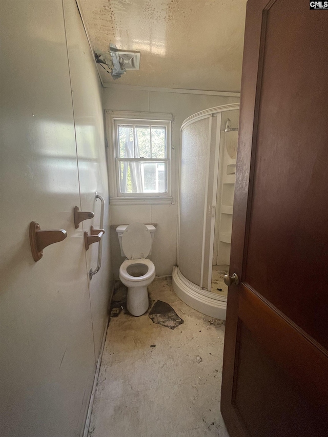 bathroom featuring a stall shower and toilet