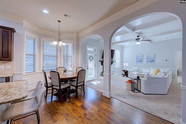 dining space with arched walkways, coffered ceiling, visible vents, beam ceiling, and dark wood finished floors