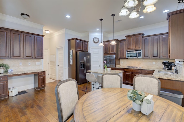 dining room with a chandelier, visible vents, dark wood-style floors, built in desk, and crown molding