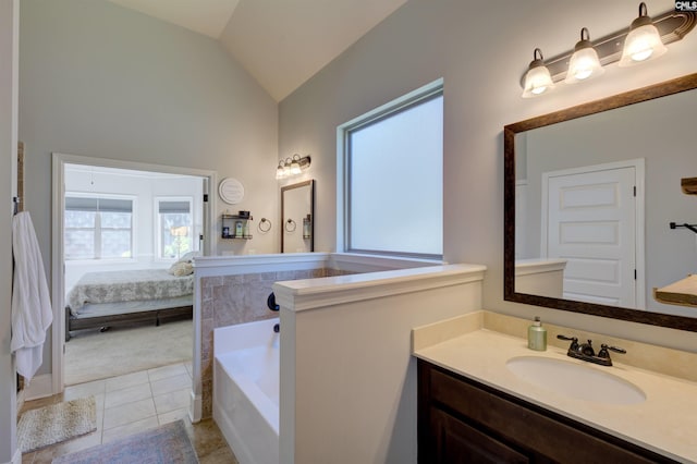 ensuite bathroom featuring lofted ceiling, ensuite bathroom, a garden tub, tile patterned flooring, and vanity