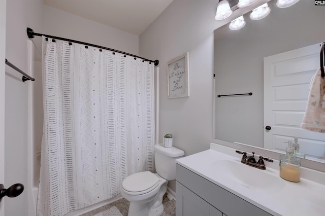 full bath with toilet, tile patterned floors, shower / tub combo, and vanity