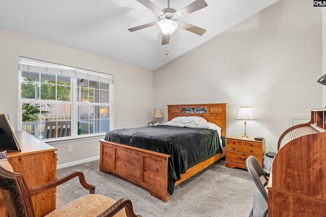 carpeted bedroom featuring a ceiling fan, lofted ceiling, and baseboards