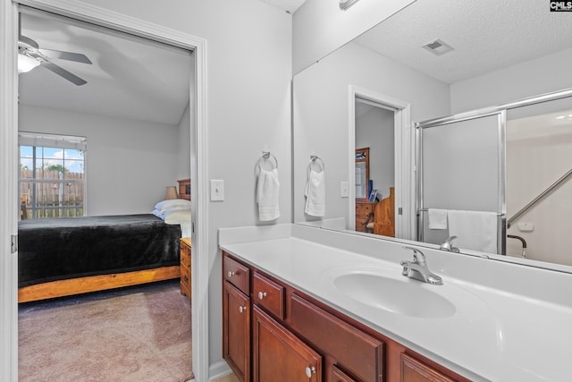 bathroom featuring visible vents, a ceiling fan, connected bathroom, a textured ceiling, and vanity