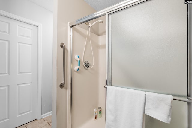 full bath featuring a stall shower and tile patterned floors