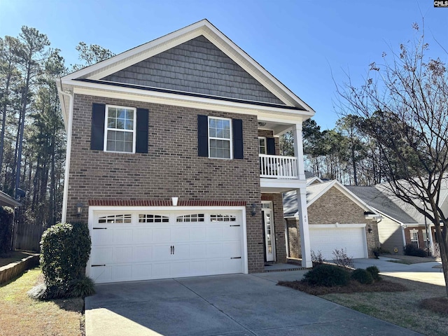 view of front of property featuring a garage, brick siding, driveway, and a balcony