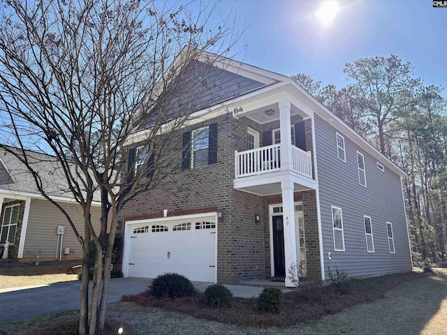 view of front facade featuring brick siding, driveway, a balcony, and an attached garage