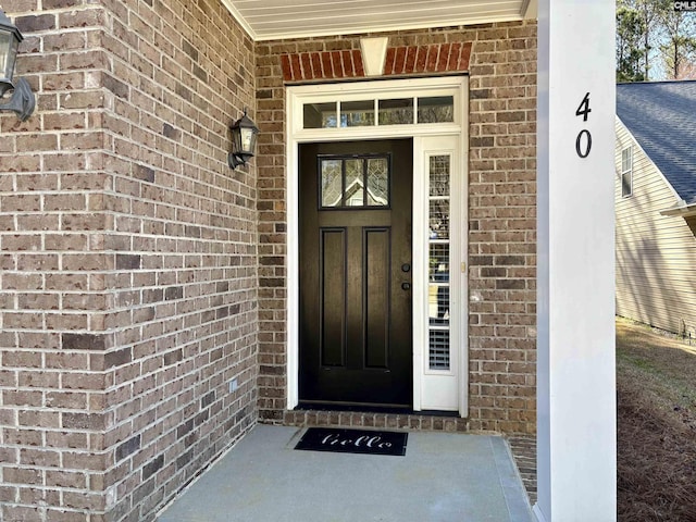 property entrance featuring brick siding