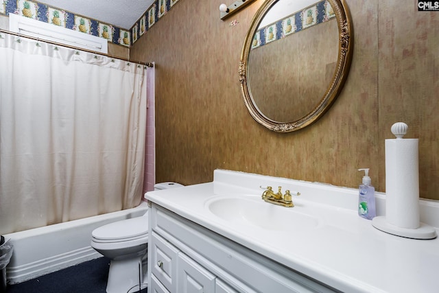 full bathroom with shower / bath combo with shower curtain, toilet, vanity, and a textured ceiling