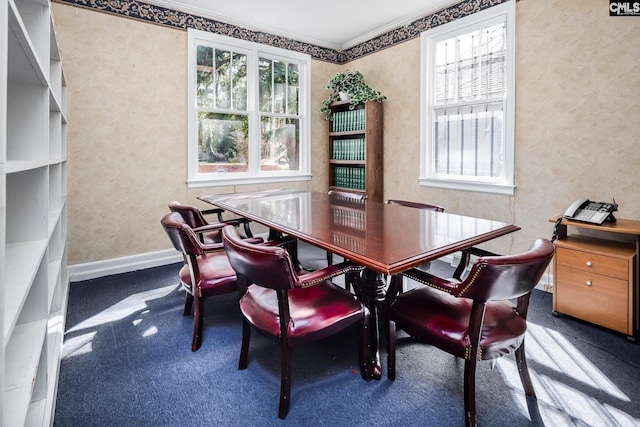 dining space featuring wallpapered walls, baseboards, and ornamental molding