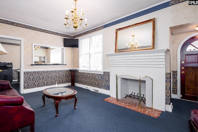 carpeted living area with a notable chandelier, wallpapered walls, baseboards, and a wainscoted wall