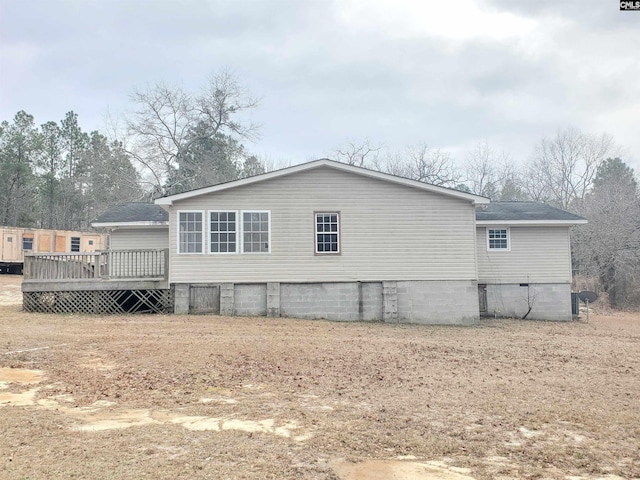 back of house featuring crawl space and a wooden deck