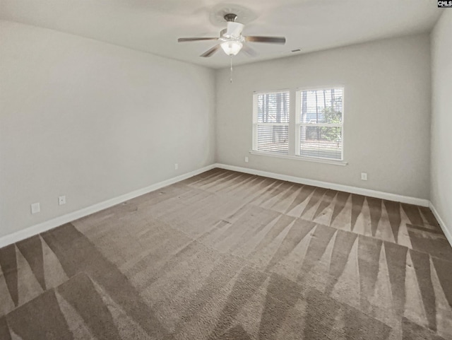 unfurnished room featuring carpet flooring, a ceiling fan, and baseboards