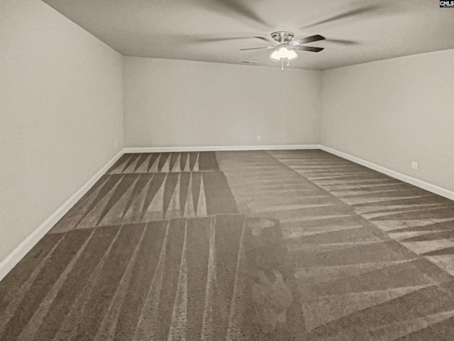 spare room with baseboards, a ceiling fan, and carpet flooring