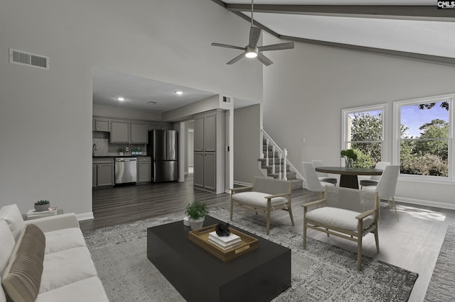 living area with baseboards, visible vents, dark wood finished floors, ceiling fan, and stairway