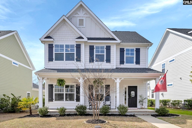 view of front of property featuring a shingled roof, a porch, and board and batten siding