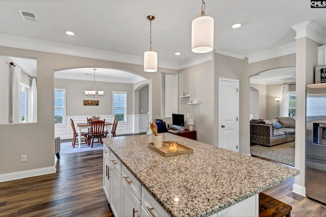 kitchen with visible vents, white cabinetry, open floor plan, stainless steel refrigerator with ice dispenser, and dark wood finished floors