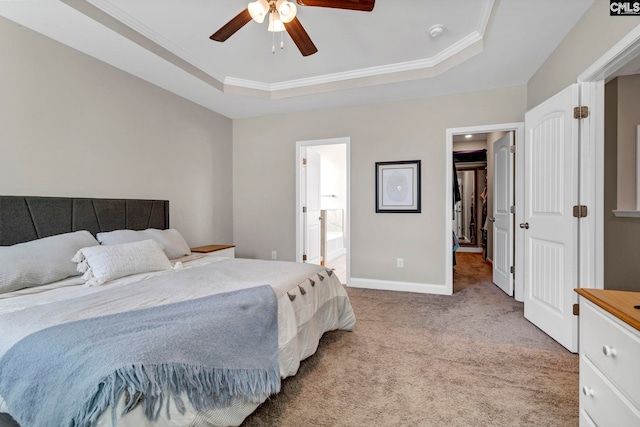 bedroom featuring baseboards, ornamental molding, a raised ceiling, and light colored carpet