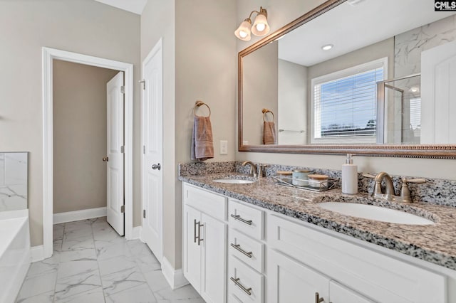 full bathroom featuring marble finish floor, a shower stall, baseboards, and a sink