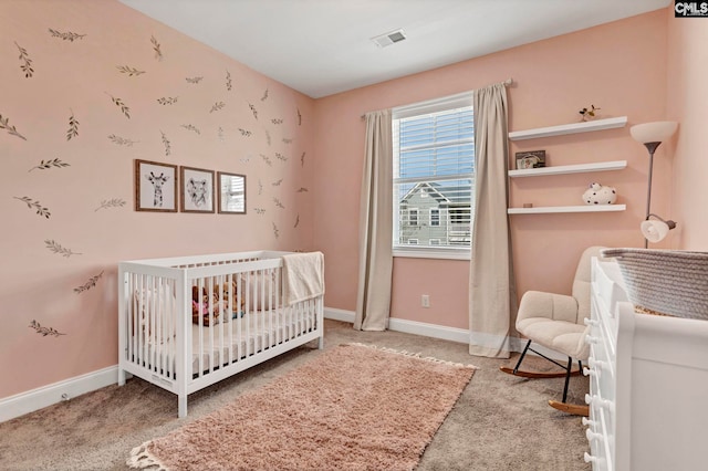 carpeted bedroom featuring a nursery area, visible vents, and baseboards