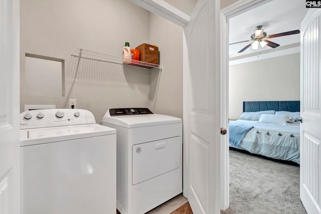 laundry area with light carpet, laundry area, washing machine and dryer, and a ceiling fan