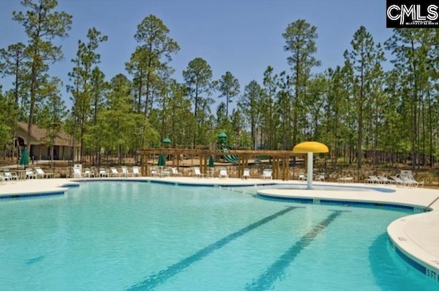 pool featuring a patio area and playground community