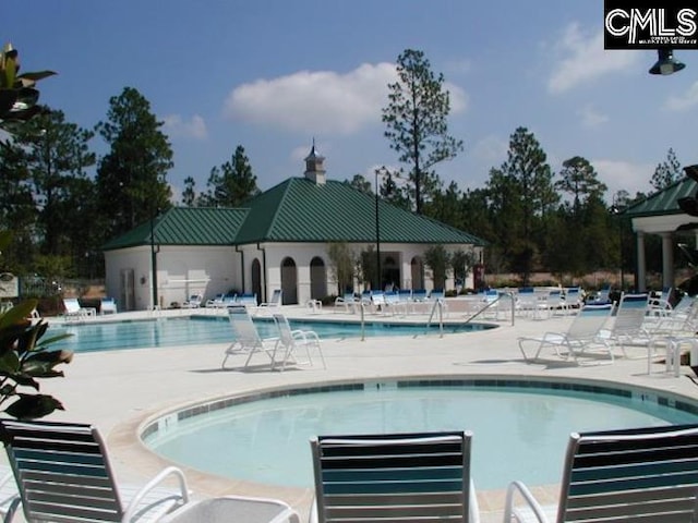 community pool featuring a patio area