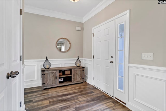 foyer entrance with wainscoting, crown molding, and wood finished floors