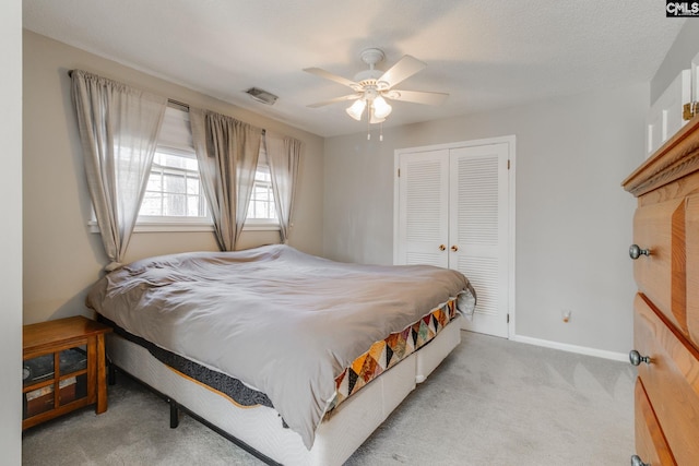 bedroom featuring carpet, a closet, visible vents, ceiling fan, and baseboards