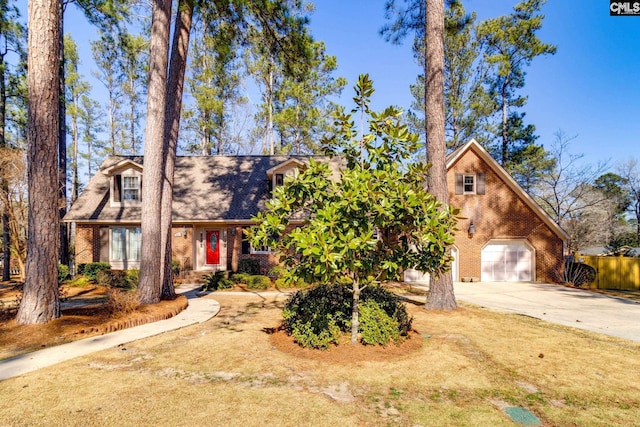 view of front of property featuring driveway, a garage, and brick siding