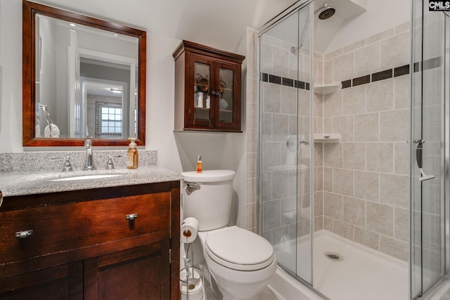 full bath with toilet, a shower stall, and vanity