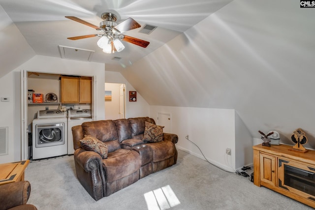 living area featuring lofted ceiling, separate washer and dryer, and visible vents