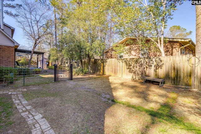 view of yard with a gate and a fenced backyard