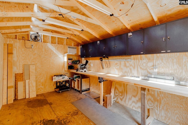 basement featuring wood walls and an AC wall unit