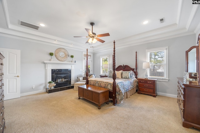 bedroom featuring a raised ceiling, visible vents, and multiple windows