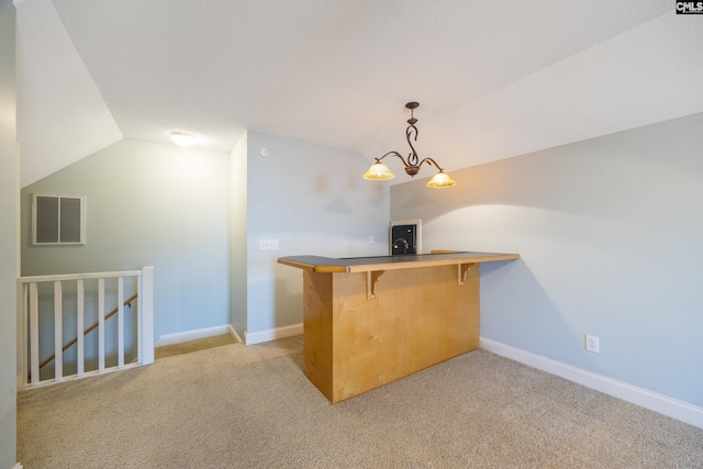 bar with pendant lighting, lofted ceiling, light colored carpet, visible vents, and baseboards