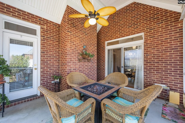 view of patio / terrace featuring a ceiling fan and an outdoor fire pit