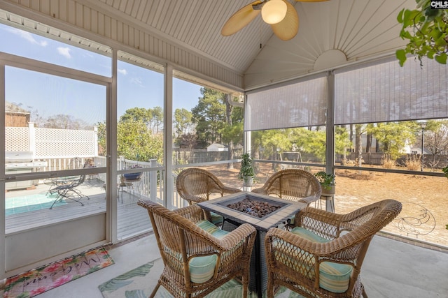 sunroom with vaulted ceiling and a ceiling fan