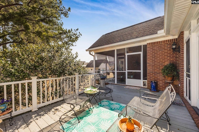 wooden deck with a sunroom