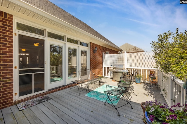 wooden deck with a grill