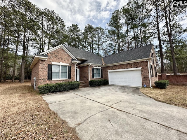 single story home featuring concrete driveway, brick siding, roof with shingles, and an attached garage