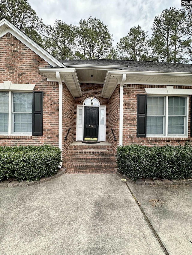 property entrance with brick siding