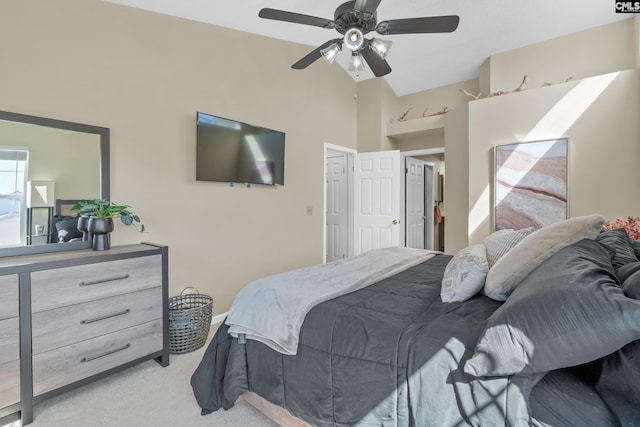 bedroom featuring a ceiling fan, light carpet, and vaulted ceiling