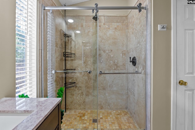 full bathroom with a stall shower and vanity