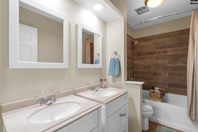 bathroom featuring two vanities, visible vents, a sink, and toilet