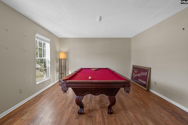 game room featuring pool table, a textured ceiling, baseboards, and wood finished floors