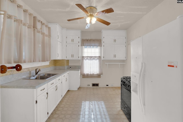 kitchen with white refrigerator with ice dispenser, light floors, visible vents, gas stove, and a sink