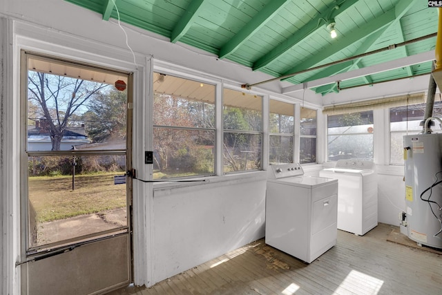 laundry room with washer and clothes dryer, water heater, light wood-style floors, a healthy amount of sunlight, and laundry area