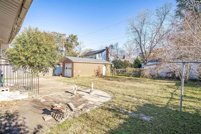 view of yard with an outbuilding, driveway, and a detached garage